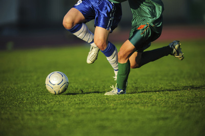 Football Players Contesting for Ball