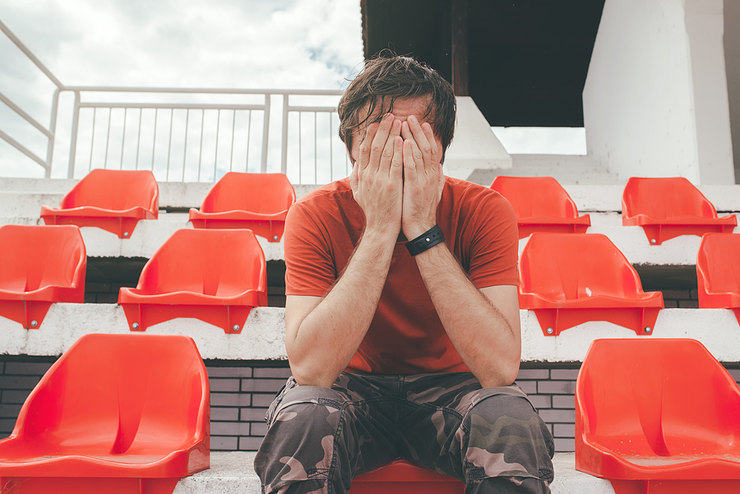 Upset Football Fan in Empty Stadium