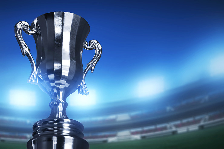 Silver Trophy with Stadium in Background
