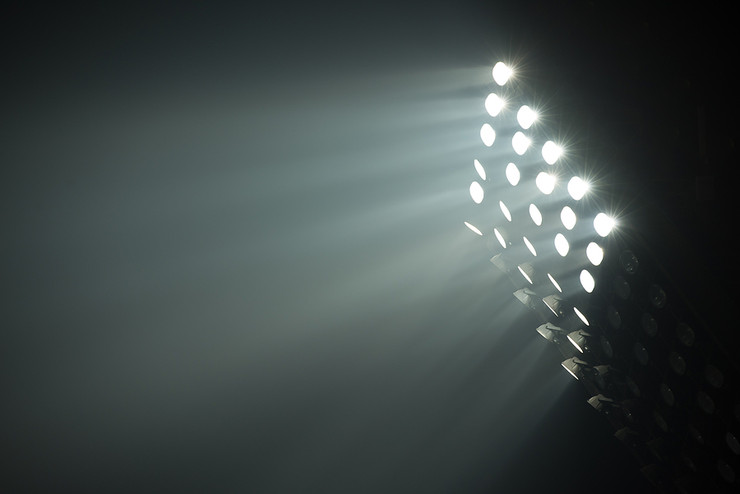 Football Stadium Floodlights Against Night Sky
