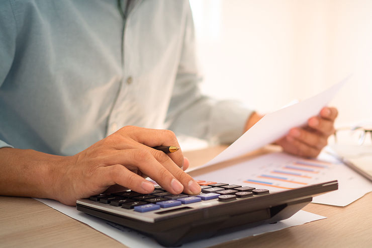 Man Using Calculator