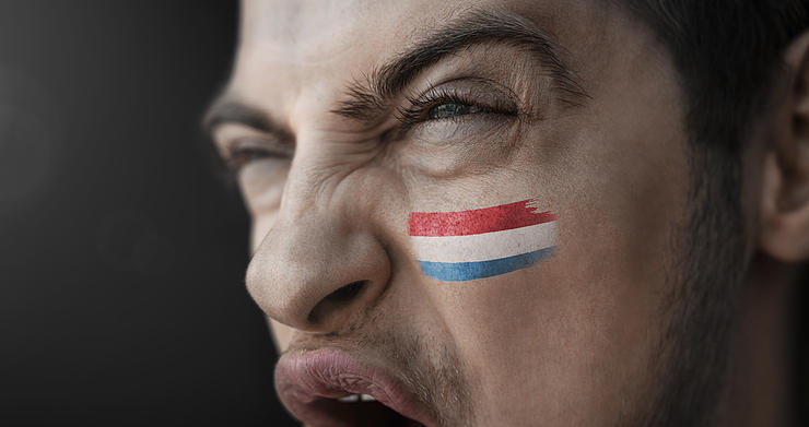 Man Screaming with Luxembourg Flag Painted on Face