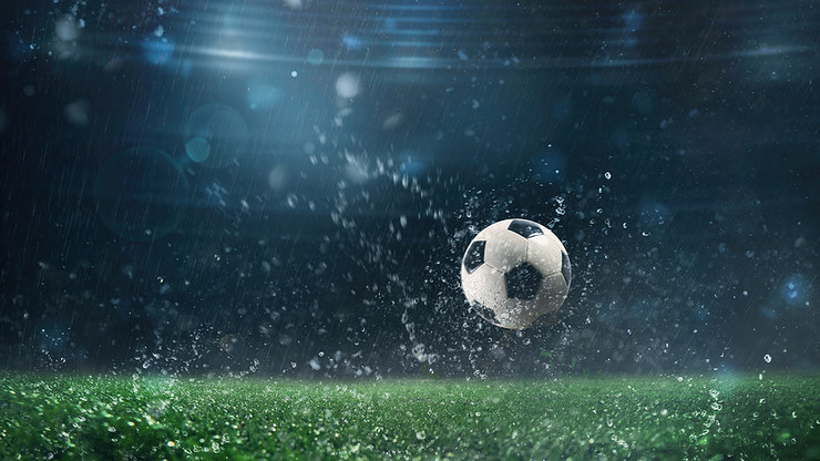 Football in Rain Bouncing on Pitch