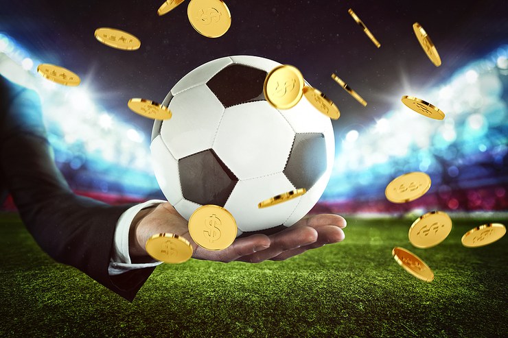 Football Held Amongst Falling Coins