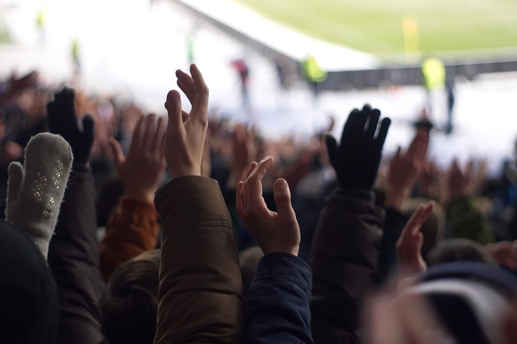 Football Fans with Hands in the Air
