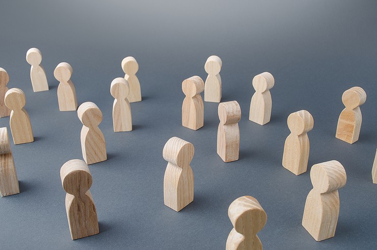Wooden Figures Against Grey Background