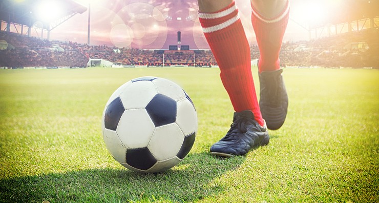 Footballer Red Socks Running with Ball