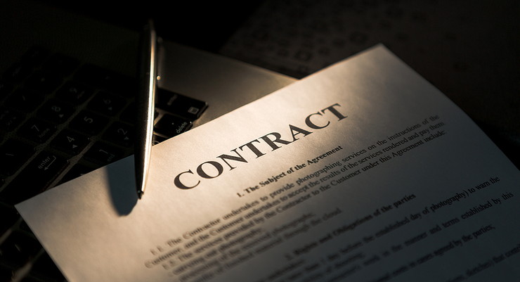 Contract and Pen on Laptop