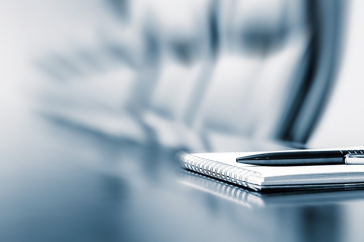 Blurred Boardroom Chair and Notepad