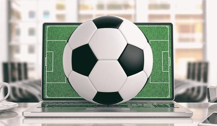 Football on Laptop in Office