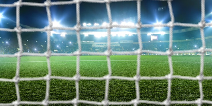 Football Stadium at Night Viewed Through Goal Net
